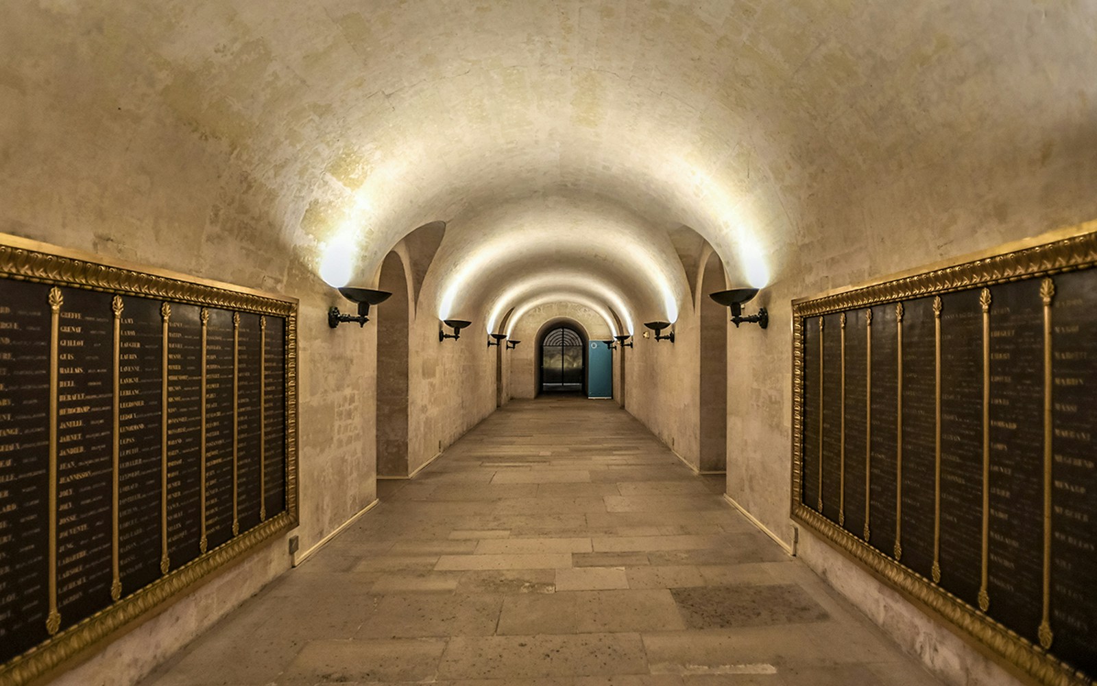 Crypt interior with stone arches and columns in Paris Pantheon.