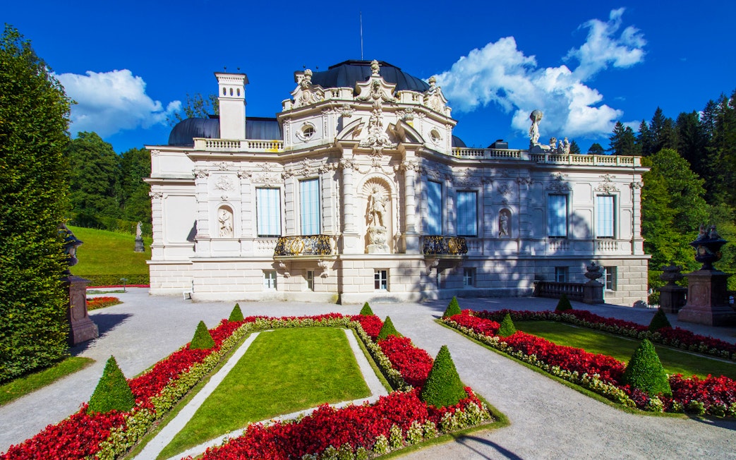 Linderhof Palace with ornate facade and manicured gardens, Germany.