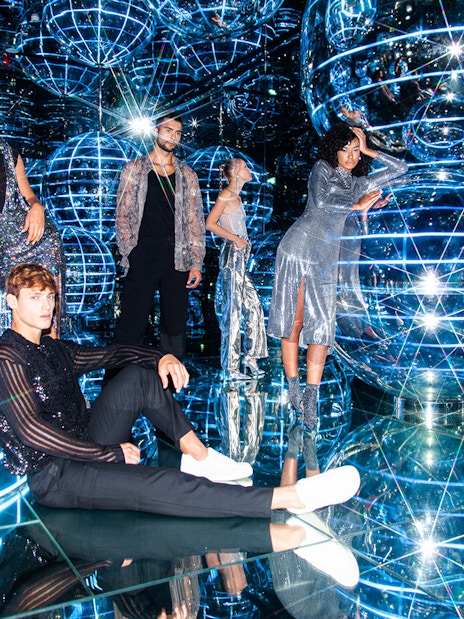 People exploring Luna installation at AYA Universe with reflective spheres and lights.