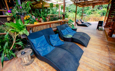 Outdoor seating area at Tree Bridge Zipline and Cafe, Koh Samui, surrounded by lush greenery.