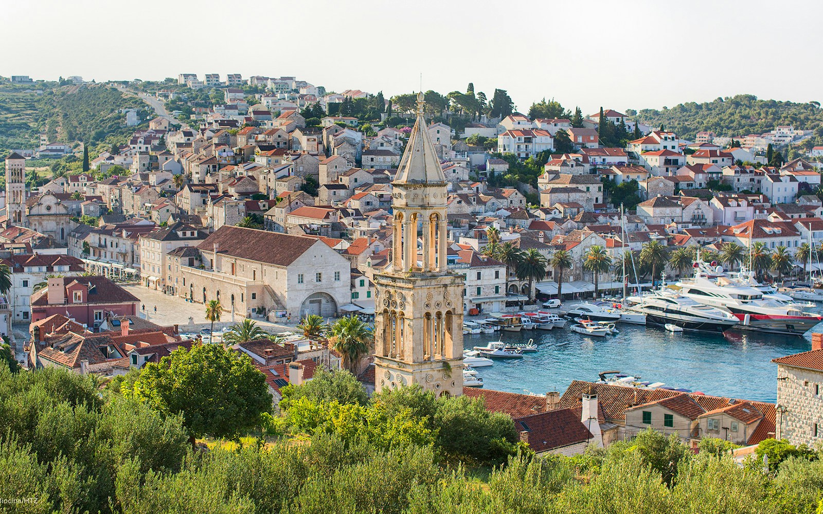 Harbor view of Hvar town with historic buildings and boats, part of Split's Blue Cave and 5 Islands tour.