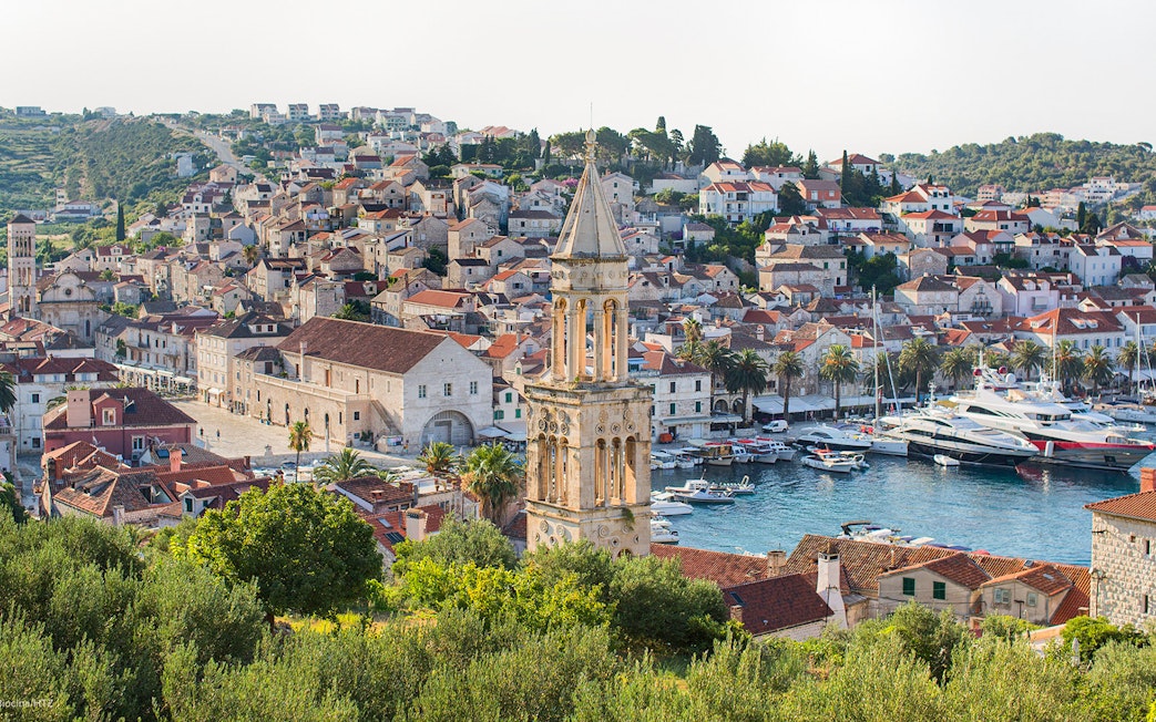 Harbor view of Hvar town with historic buildings and boats, part of Split's Blue Cave and 5 Islands tour.