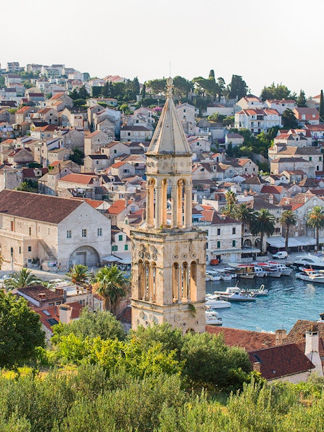 Harbor view of Hvar town with historic buildings and boats, part of Split's Blue Cave and 5 Islands tour.