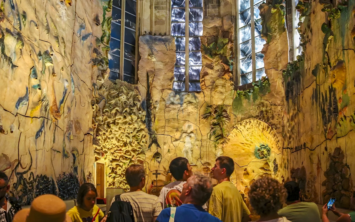 Tourists observing the intricate design inside Barcel Chapel, Palma Cathedral.