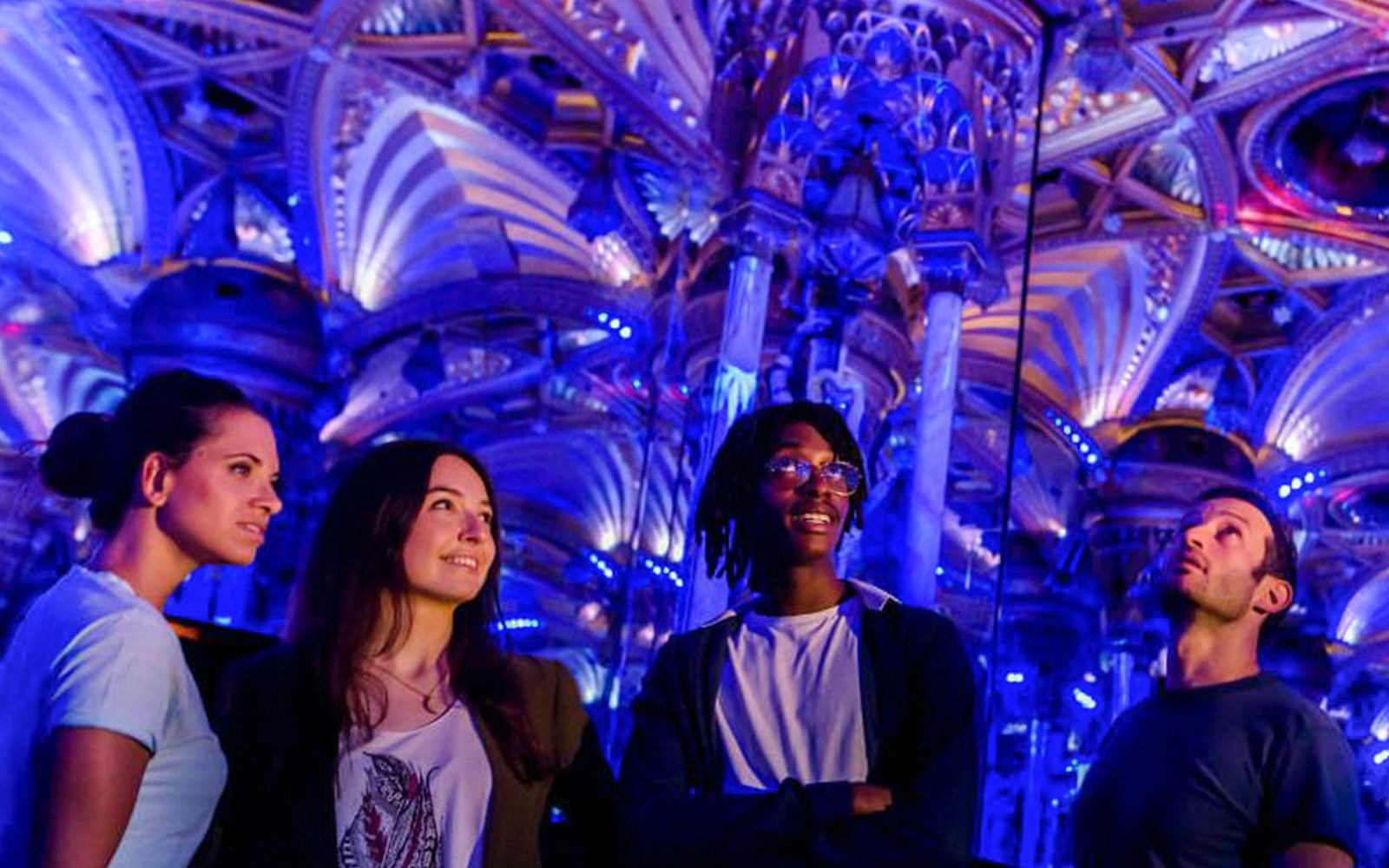 Visitors admire ornate ceiling at Grévin Paris Wax Museum.