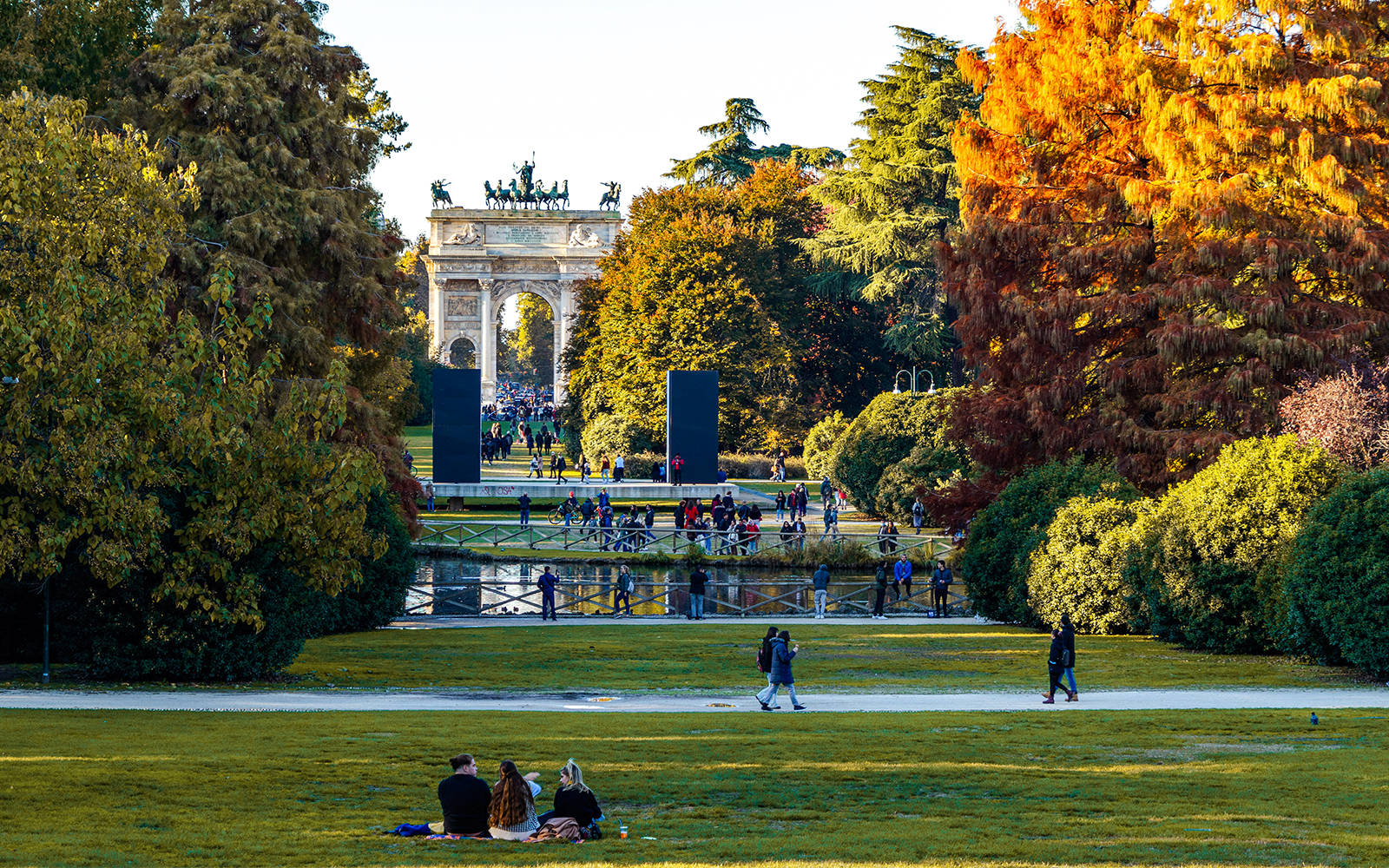 Parco Sempione in Milan with autumn foliage and Sforza Castle in the background, Italy.