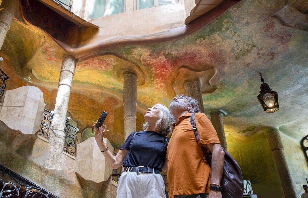 Visitors admiring the colorful interior of Casa Milà in Barcelona.