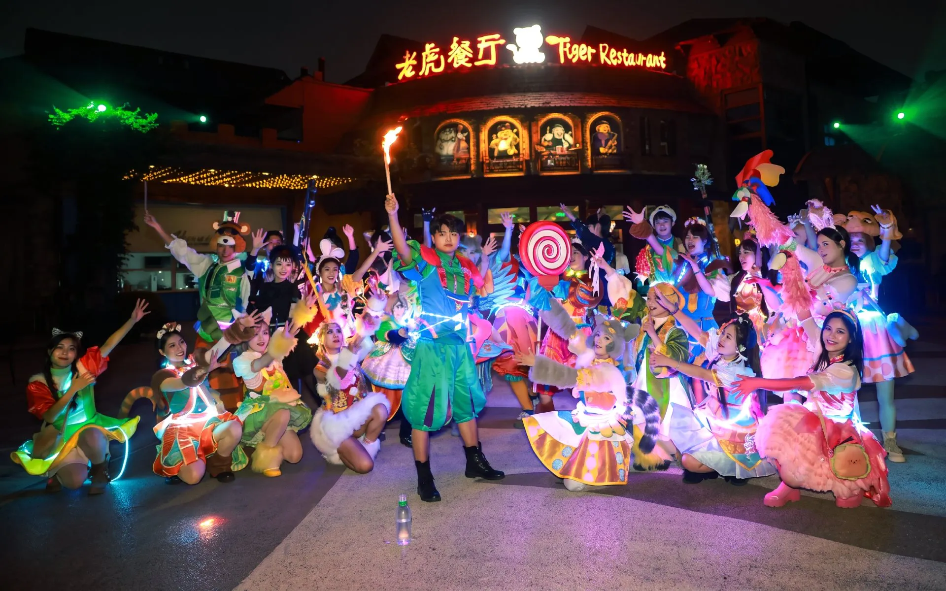 Performers in colorful costumes at Shanghai Wild Animal Park night show.
