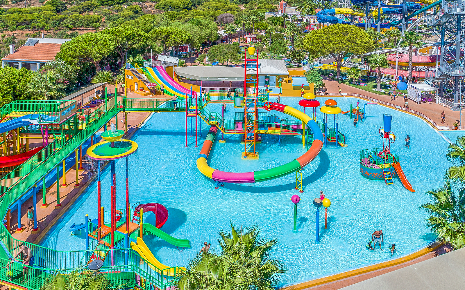 Children enjoying water slides at Mini Park Aquashow Park, Portugal.