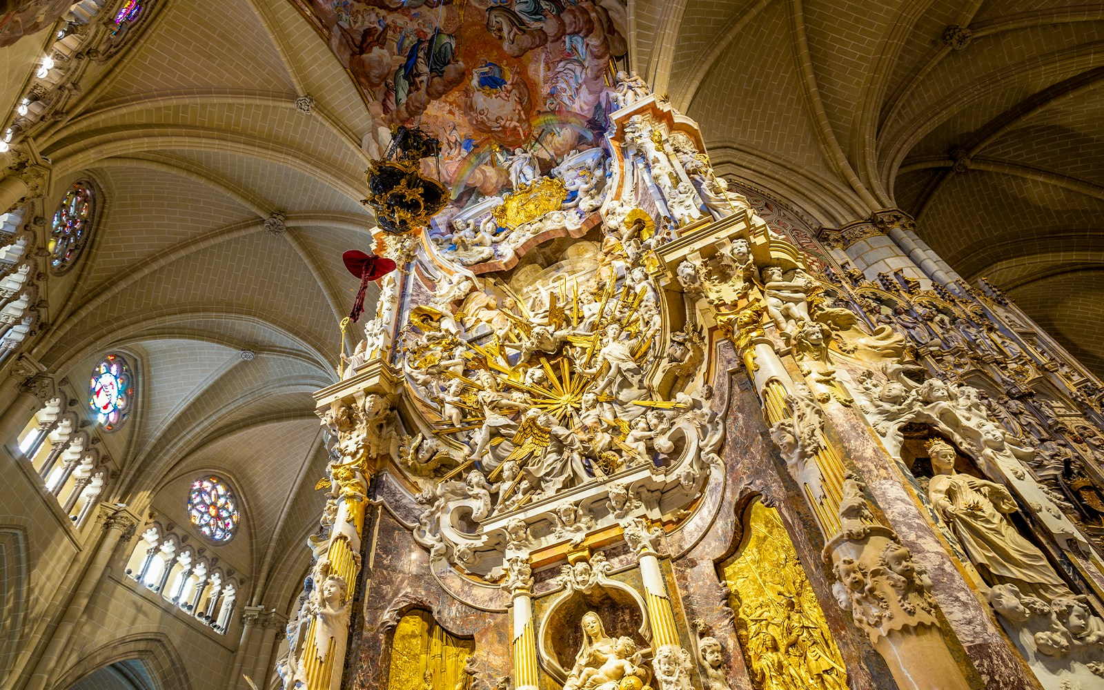 El Transparente sculpture in Toledo Cathedral interior, featuring intricate carvings and celestial figures.