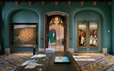 Gruuthusemuseum interior with historical map and paintings in Bruges, Belgium.
