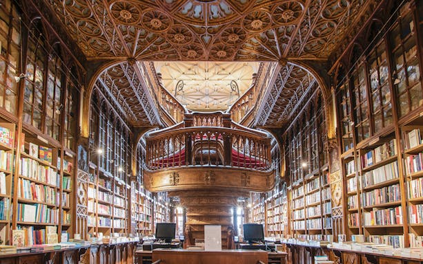 Lello Library's ornate wooden staircase and bookshelves, Porto City Full-Day Tour.