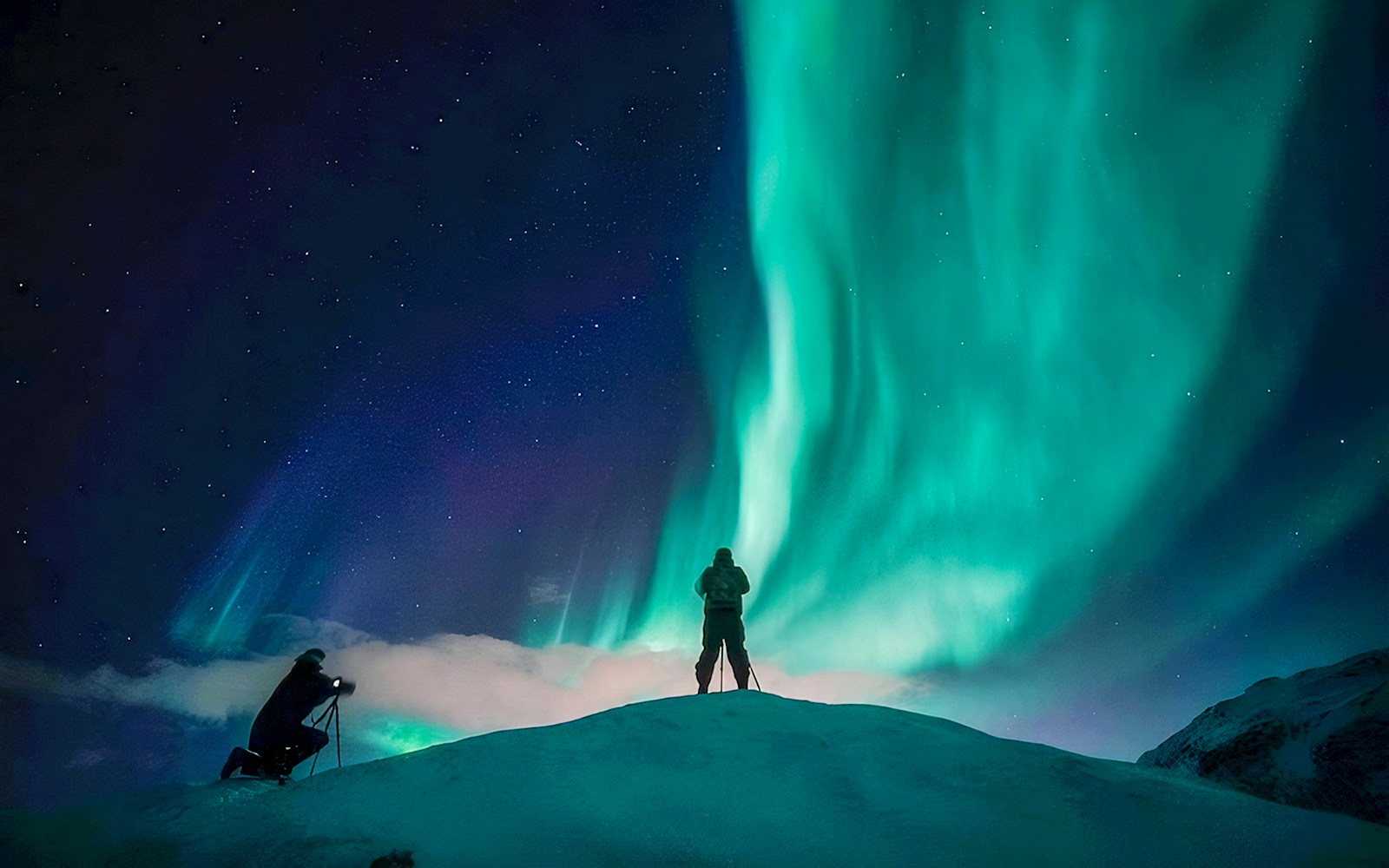 Guests photographing Northern Lights during Tromso tour.