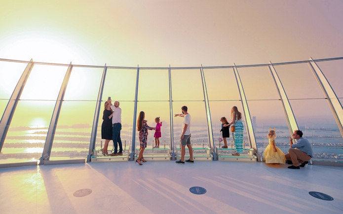 Visitors enjoying panoramic views from the Palm Tower observation deck in Dubai.