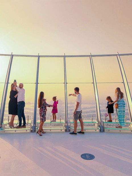 Visitors enjoying panoramic views from the Palm Tower observation deck in Dubai.