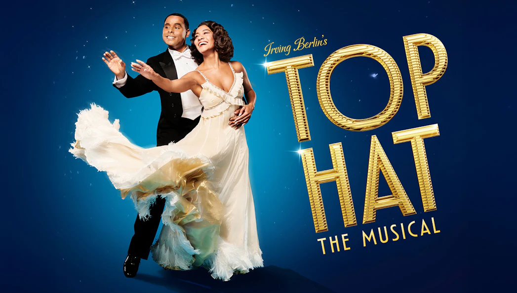Dancers in formal attire performing for "Top Hat" musical.
