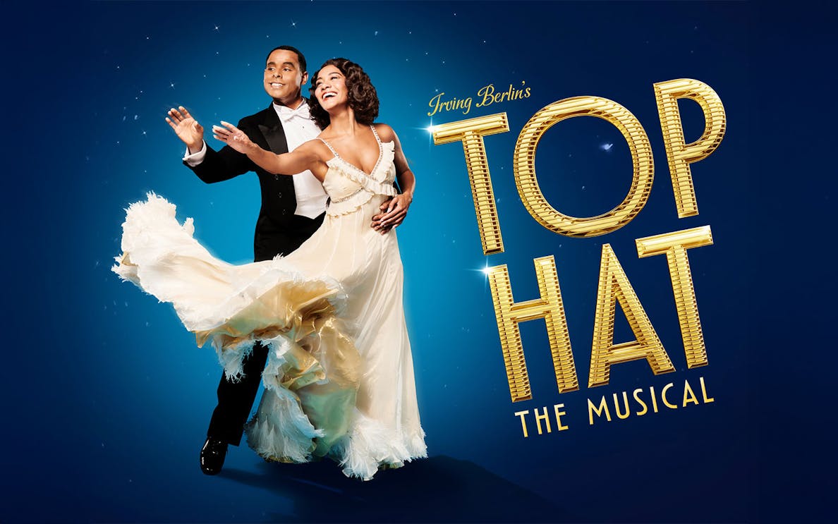 Dancers in formal attire performing for "Top Hat" musical.