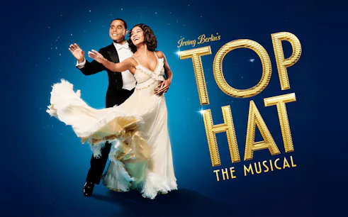 Dancers in formal attire performing for "Top Hat" musical.