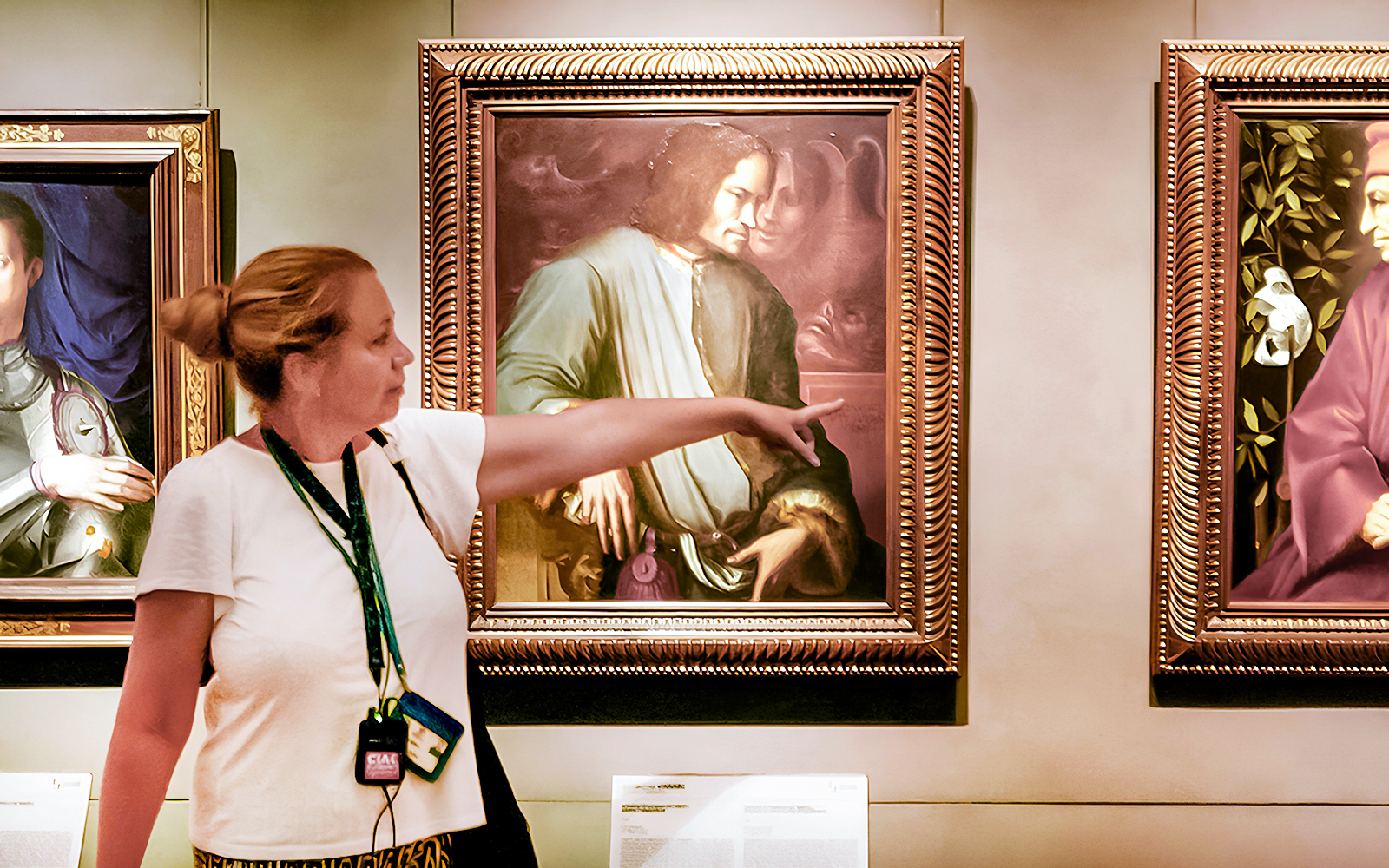 Tour guide pointing at painting in Uffizi Gallery, Florence Wonders tour.