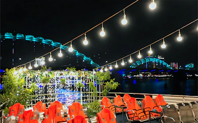 My Xuan Cruise deck on Han River at night with city lights and bridge in view.