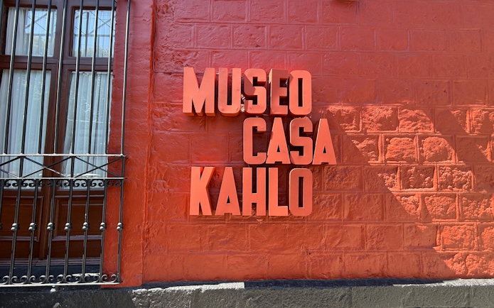 Frida Kahlo Museum sign on red wall at La Casa Roja.