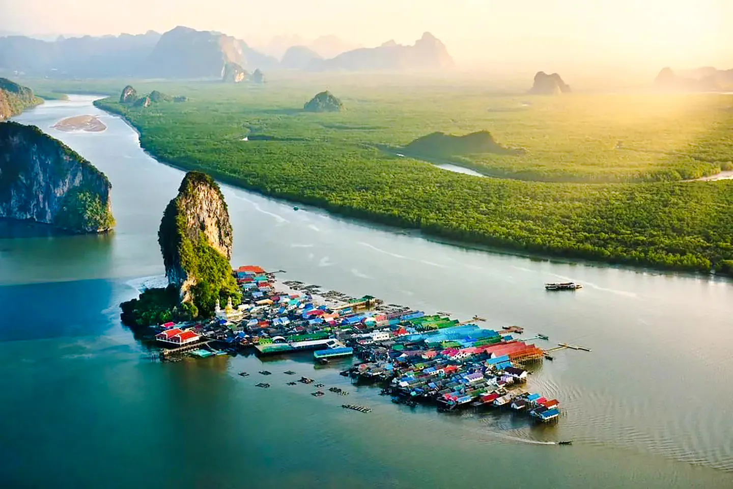Floating village near limestone cliffs in Phang Nga Bay, Phuket, Thailand.