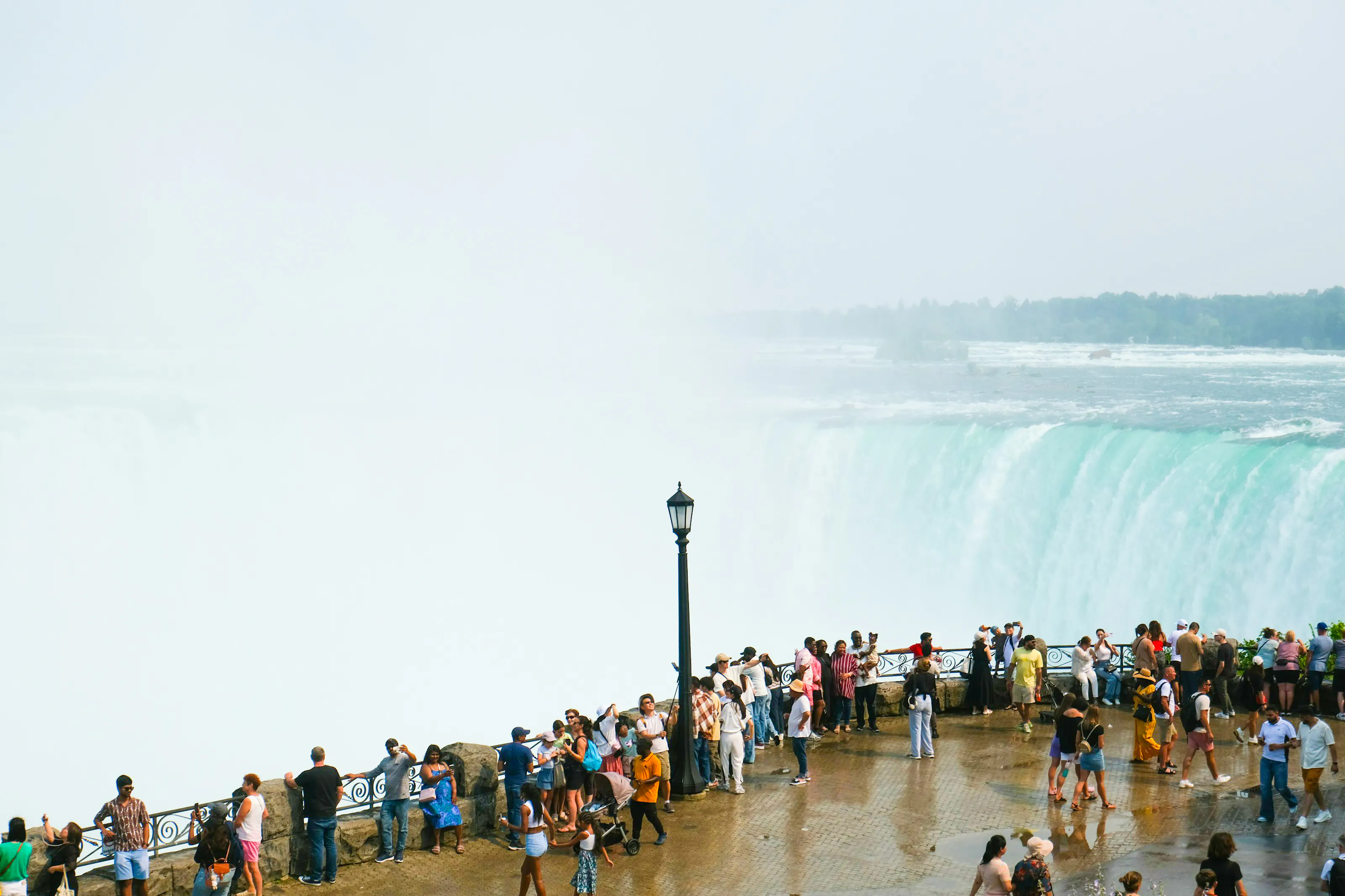 Visitors viewing Niagara Falls from a lookout point on a Toronto day tour.