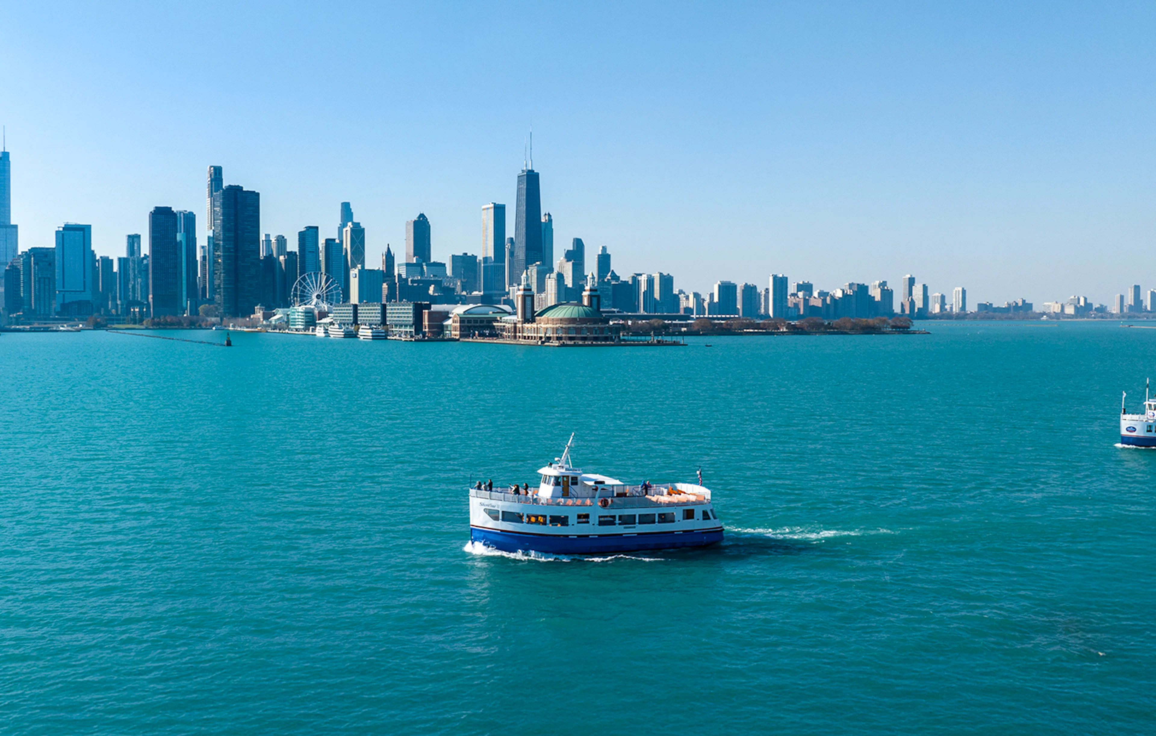 Cruise boat on Lake Michigan with Chicago skyline in the background.
