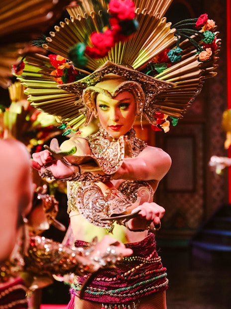 Performer in elaborate costume at Moulin Rouge Show, Paris.