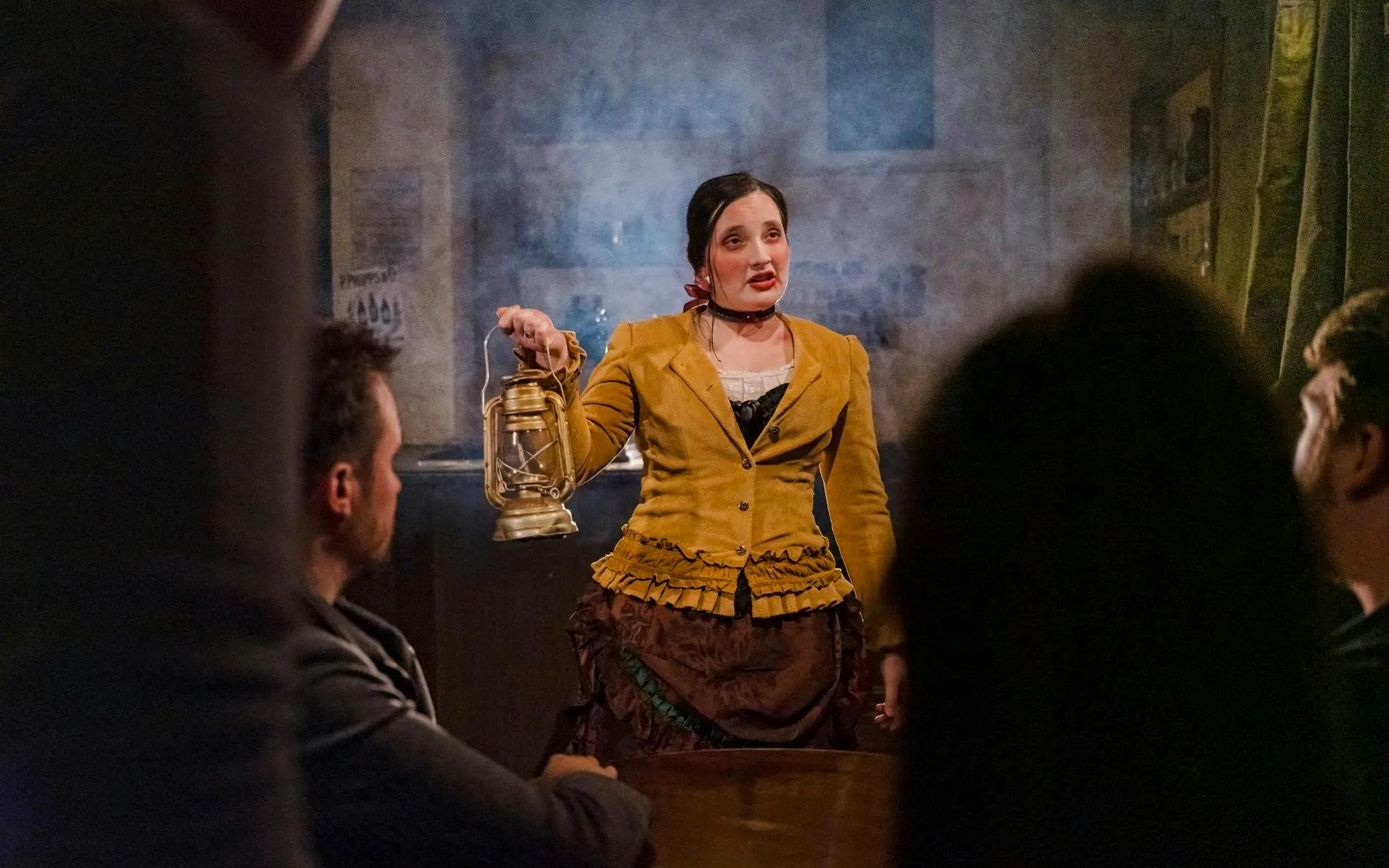 Performer with lantern during London Dungeon VIP experience.