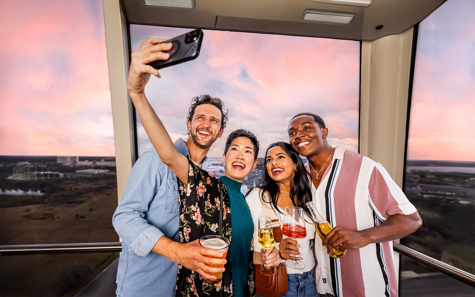 Group taking a selfie inside the ICON Park observation wheel in Orlando.