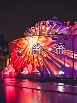 Colorful lights projected on Széchenyi Thermal Bath during Sparty event in Budapest.
