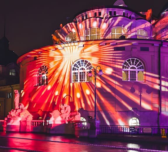 Colorful lights projected on Széchenyi Thermal Bath during Sparty event in Budapest.