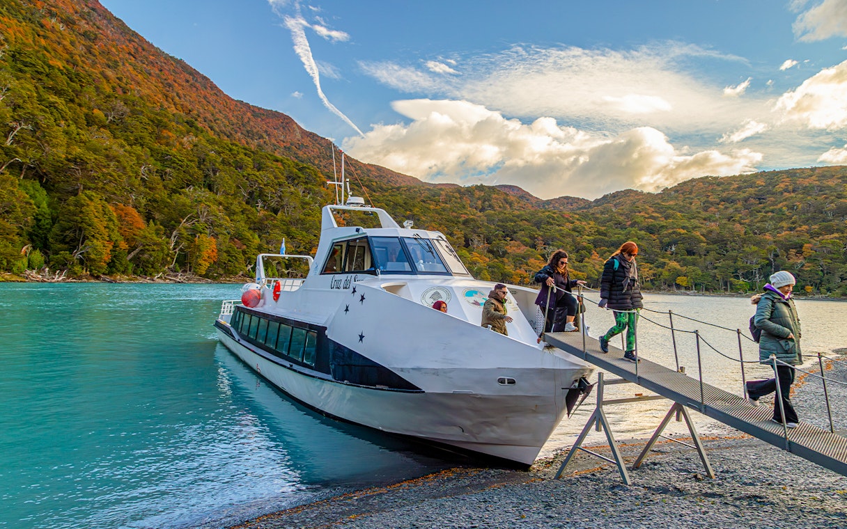 Passengers deboarding a boat for Mayo Spirit Trek on Lake Argentino, Patagonia, Argentina.