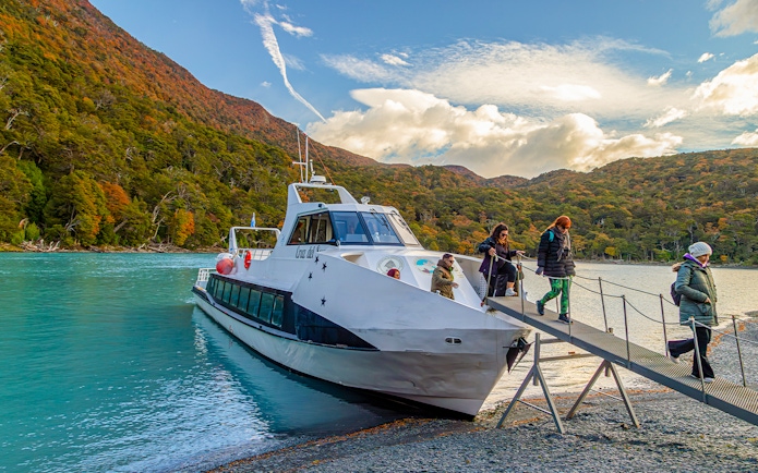 Passengers deboarding a boat for Mayo Spirit Trek on Lake Argentino, Patagonia, Argentina.