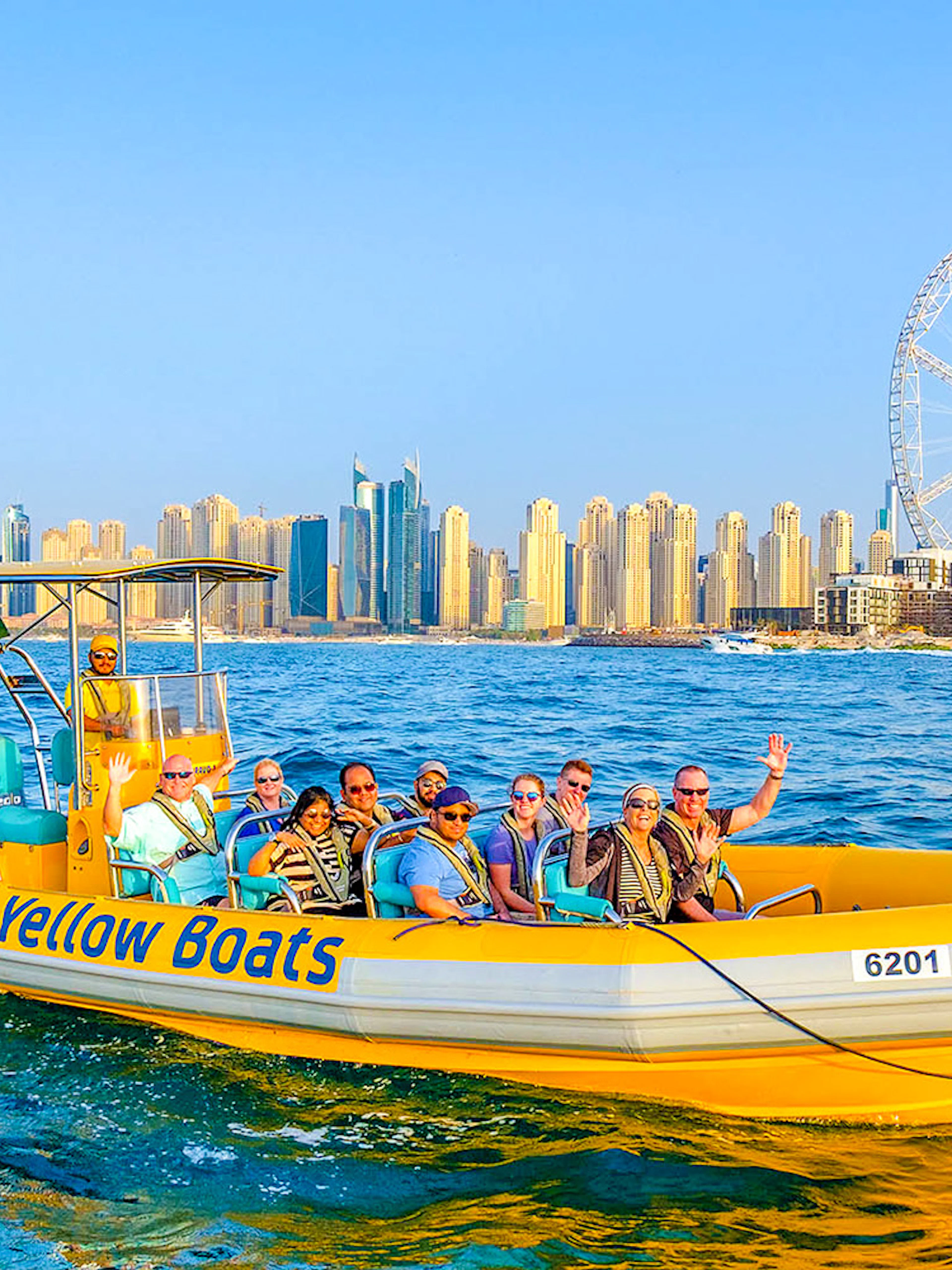 Speedboat tour in Dubai Marina with city skyline and Ferris wheel in background.
