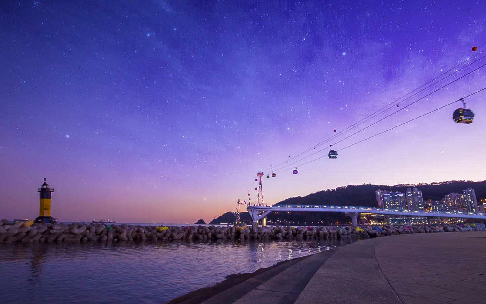 Songdo Marine Cable Car over Busan coastline at twilight.