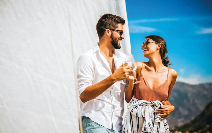 Couple enjoying drinks on a boat during Algarve sunset experience.