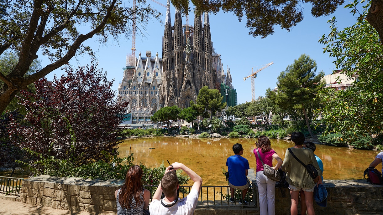 Tourists viewing Sagrada Familia construction in Barcelona.