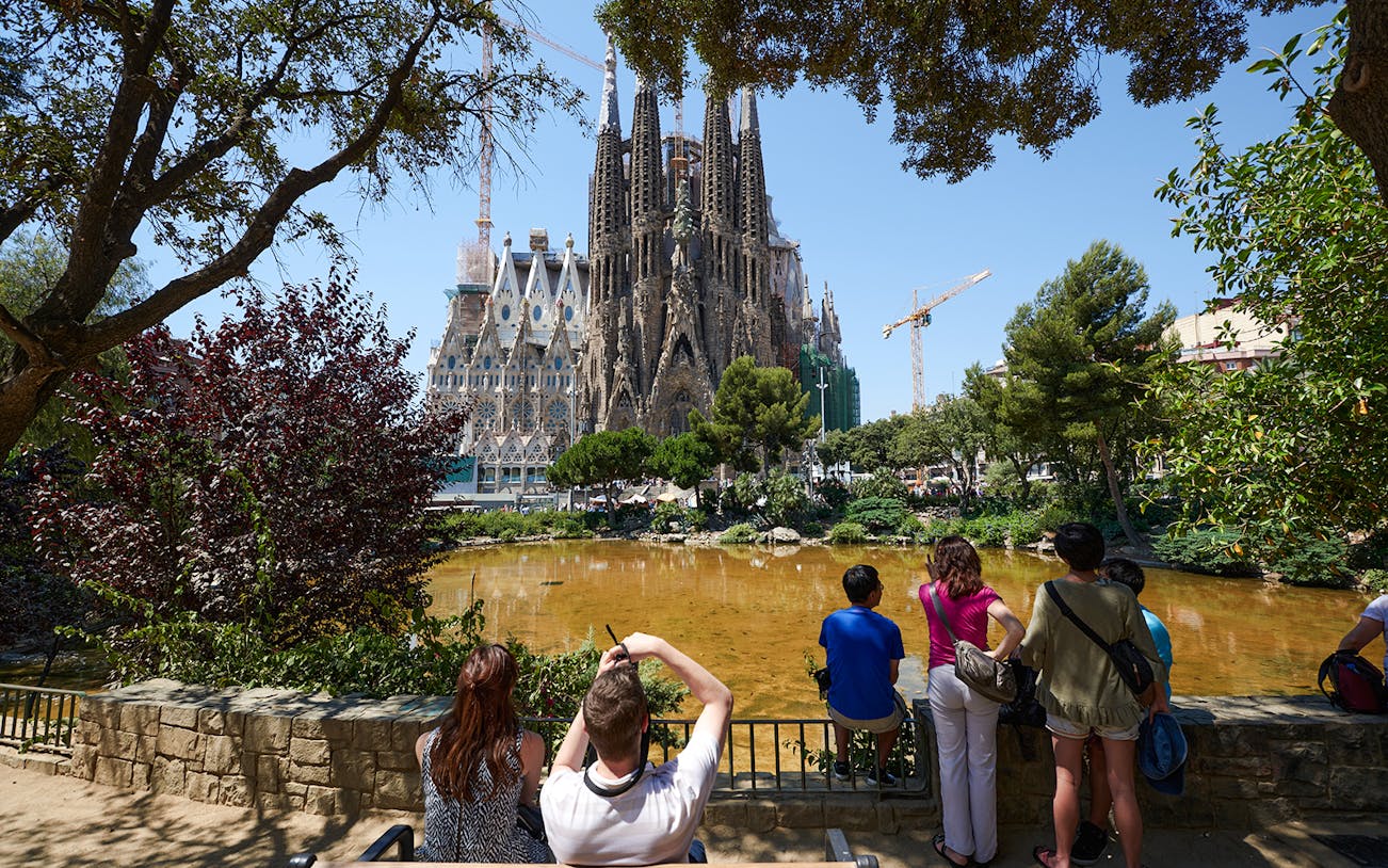 Tourists viewing Sagrada Familia construction in Barcelona.
