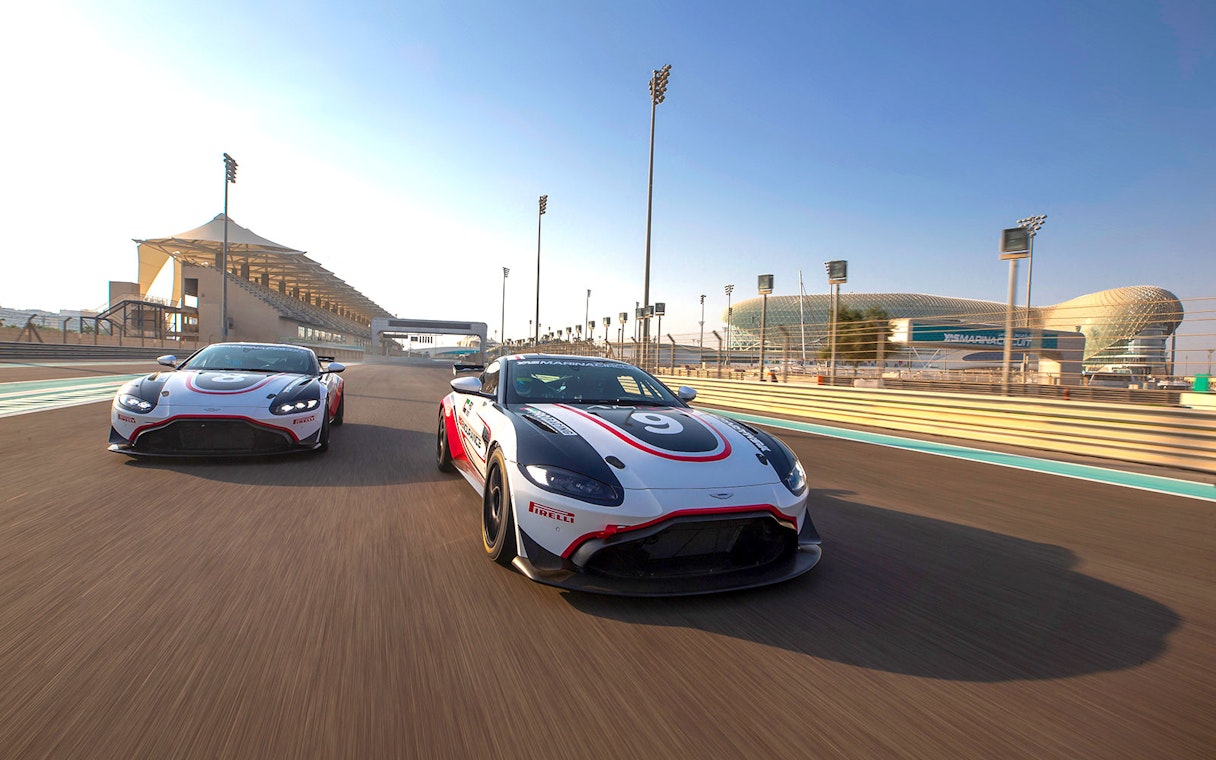 Aston Martin GT4 cars racing at Yas Marina Circuit, Abu Dhabi.
