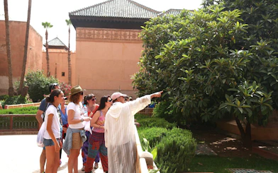 Tour group exploring gardens at Bahia Palace, Marrakech.
