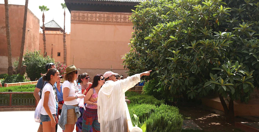 Tour group exploring gardens at Bahia Palace, Marrakech.