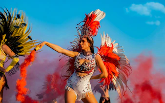 Carnival dancer in vibrant feathered costume at Rio Carnival.