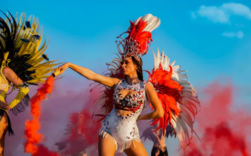Carnival dancer in vibrant feathered costume at Rio Carnival.
