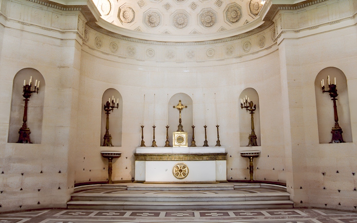 Expiatory Chapel altar with ornate candlesticks and crucifix in Paris, France.