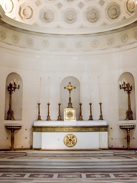 Expiatory Chapel altar with ornate candlesticks and crucifix in Paris, France.