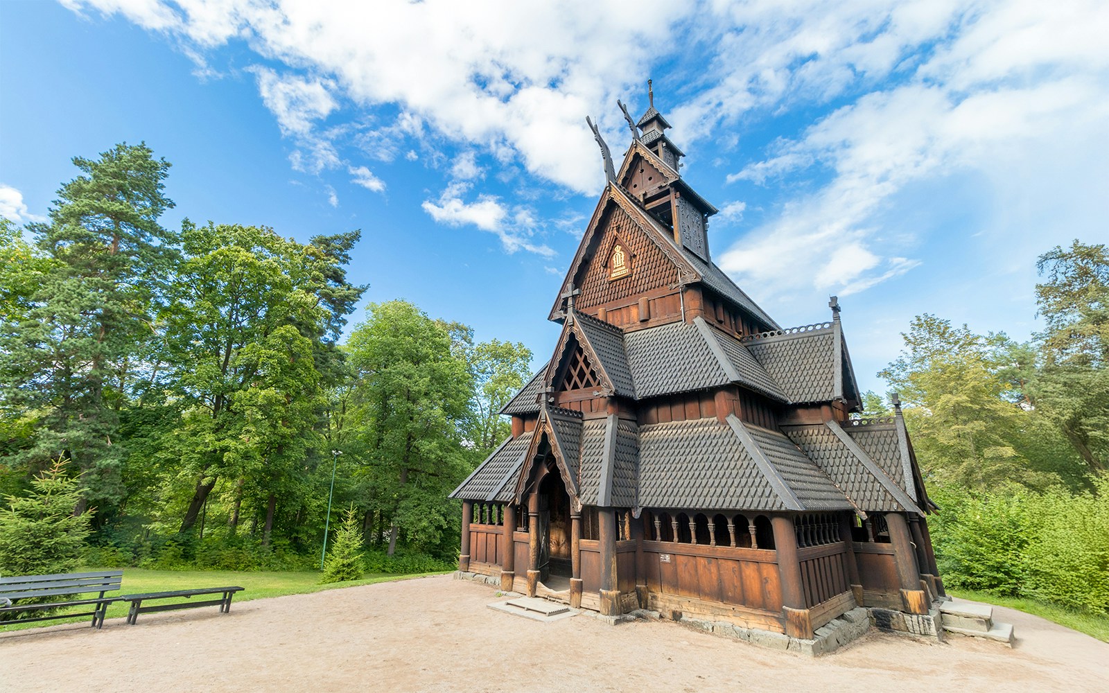 Stave church at the Norwegian Museum of Cultural History, Oslo, surrounded by trees.