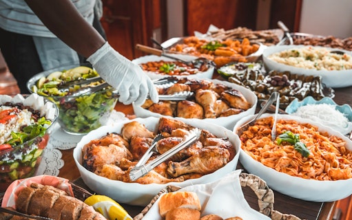 Buffet spread with grilled chicken, pasta, salad, and bread on Athens sunset dinner cruise.