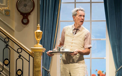 Actor holding a tray during HAY FEVER performance, Westend theater scene.